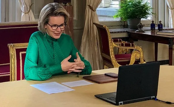 Queen Mathilde wore a rosetta insignia green bow-detail crape blouse by Carolina Herrera