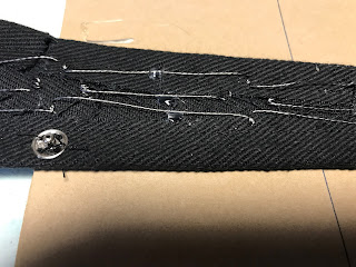 Backside of jacket attachment, showing clasps & conductive thread