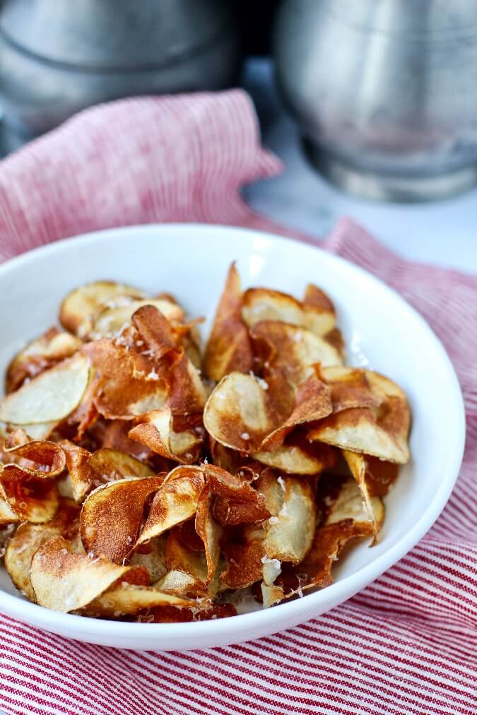 Homemade potato chips sprinkled with parmesan Homemade potato chips sprinkled with parmesan