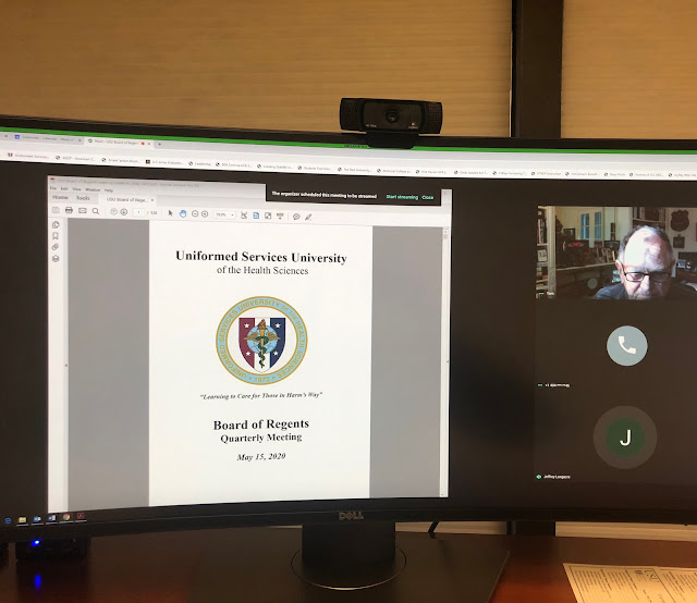 A photo of a computer with a virtual presentation of the Board of Regents Report