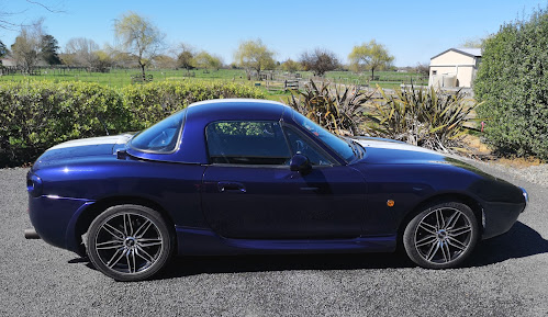 Side view of Mazda Miata with hardtop