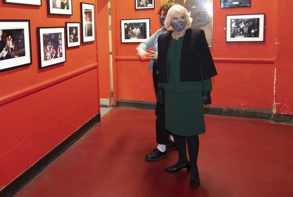 The Duchess of Cornwall wore a green skirt suit and black cape