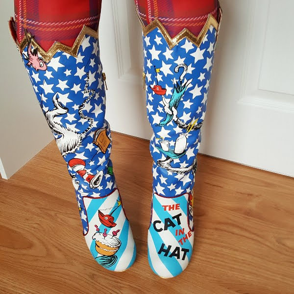front view wearing star print boots with Dr Seuss illustrations and contrast stripes