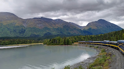 train along river forest and mountains in Alaska
