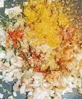 Mixing masala with onions and spices for paneer tikka masala recipe