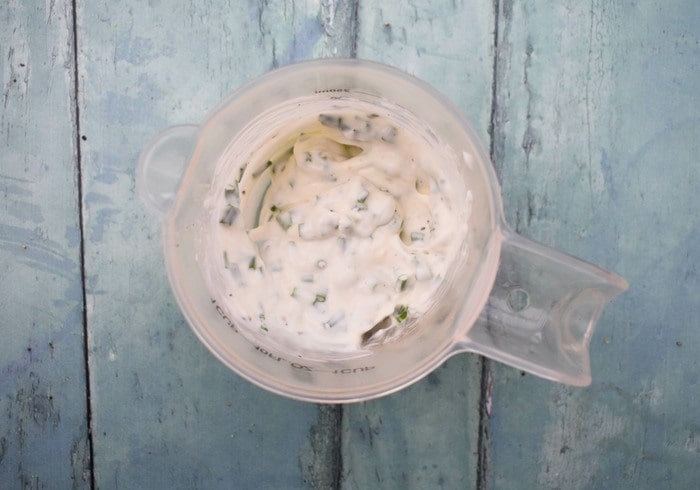 creamy lemon chive dip mixed in a small measuring jug