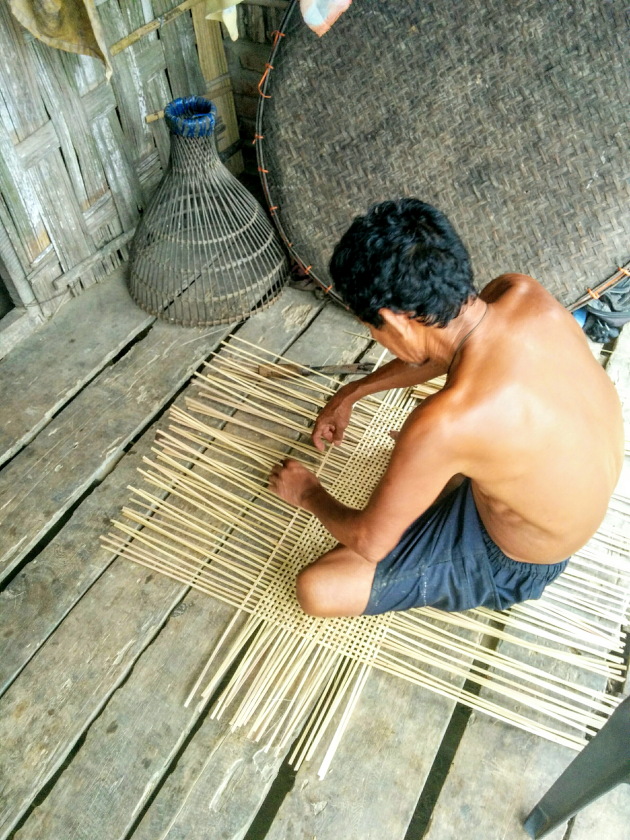 Elderly Mishing tribal man weaving a basket, Assam