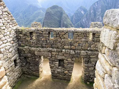 Machu Picchu Photos: Two trapezoidal doors at Machu Picchu with views of the Andes beyond.