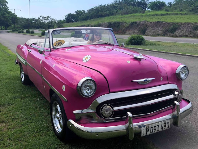 Tourist in pink vintage car