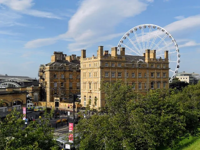 Ferris wheel and stone building in York UK