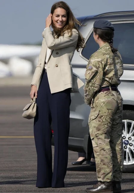 Kate Middleton wore a new double-breasted blazer by Reiss Larsson, and high waisted sport luxe trousers by Jigsaw