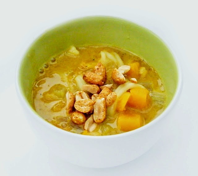 Squash, Carrot & Noodle Soup Squash, Carrot & Noodle Soup topped with roasted peanuts in a small white bowl