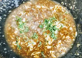 Chicken manchow soup topped with chopped coriander