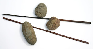 Photo of a pair of chopsticks with three pebbles