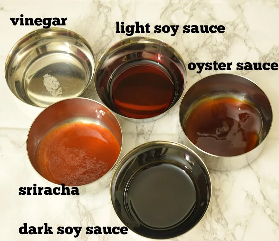 ingredients to make the sauce for chicken fried rice - vinegar,light soy sauce,dark soy sauce,oyster sauce,sriracha,sugar
