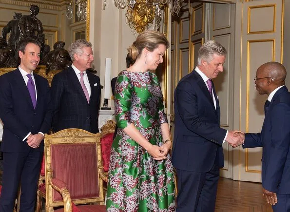 Queen Mathilde wore a green floral-print satin dress by Natan. Édouard, baron Vermeulen is a Belgian fashion designer. Natan red suede pumps