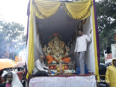 A Huge Ganpati idol being brought for visarjan in a truck