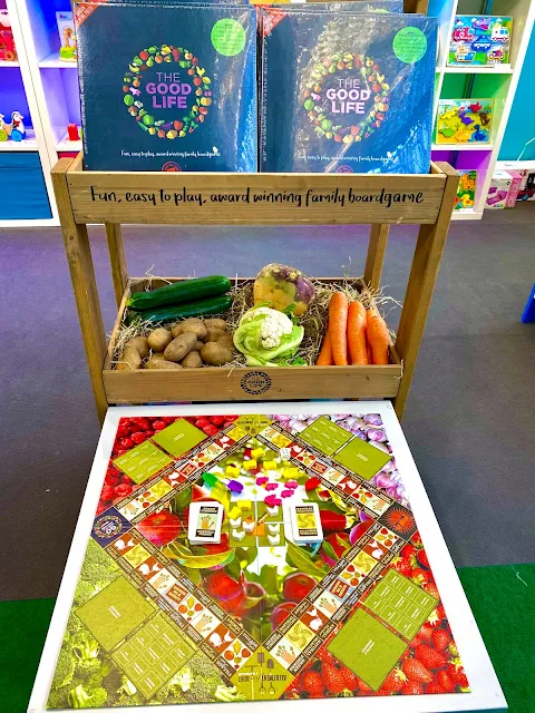 The Good Life board game aims to teach about sustainability  Image shows a board game a bit like monopoly, but covered in pictures of fruit and vegetables and with little wooden pieces to collect