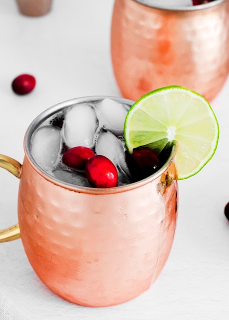 Cranberry Moscow Mule close up with fresh cranberries and lime