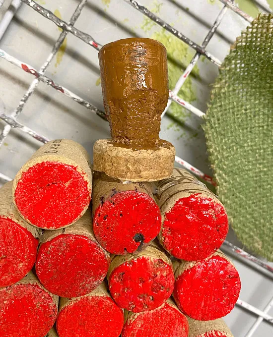 red painted apple with cork stem and leaf