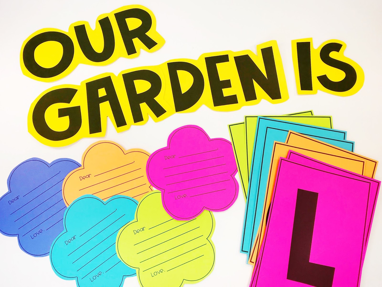 An "Our Garden Is" wall heading with writing templates for students