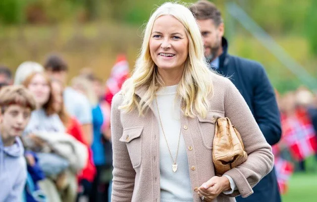 Crown Princess Mette-Marit wore a wool cashmere jacket by Gabriela Hearts. Crown Princess wore purple diamond gold earrings by Pomellato