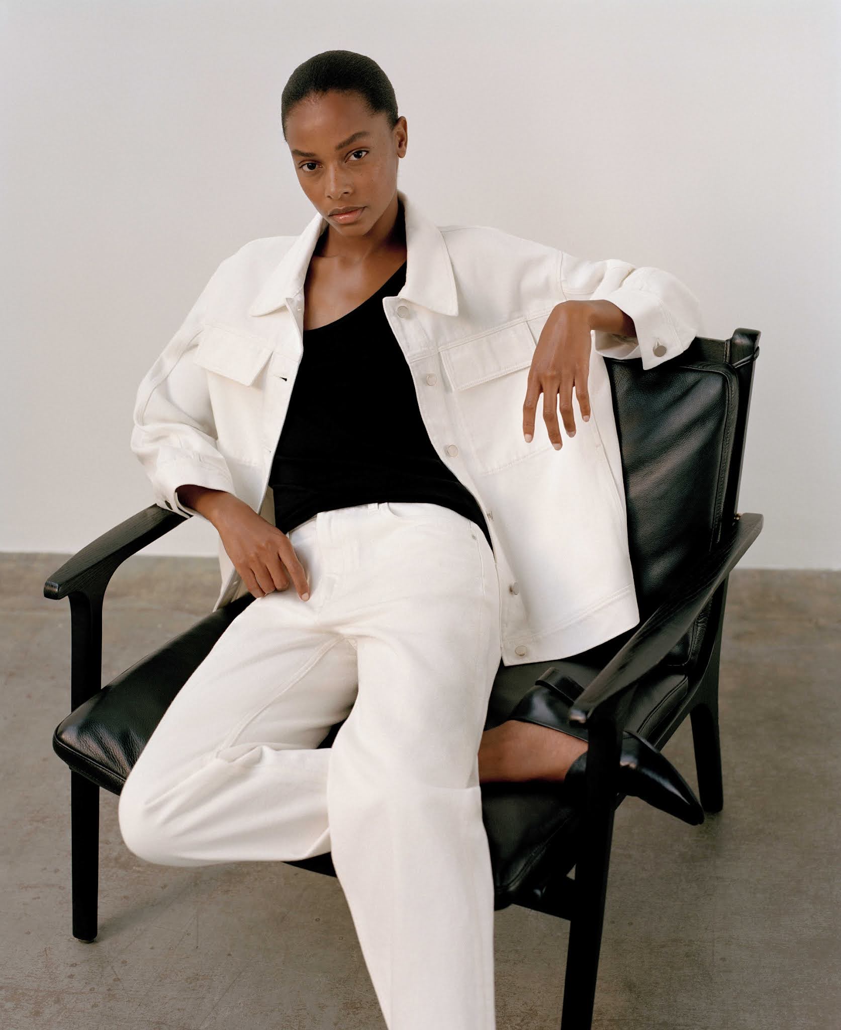 5 Minimalist Fall Outfit Ideas — Capsule Wardrobe with with a white denim jacket, black top and white jeans