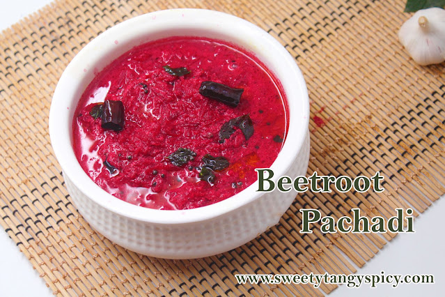 A vibrant and visually appealing bowl of Beetroot Pachadi, garnished with curry leaves and red chilies, served with a side of steamed rice, creating a delightful South Indian meal.