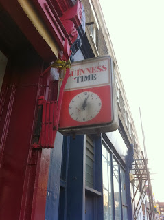  Old advertising sign and clock for "Guinness Time", Greyhound Road, Fulham, London