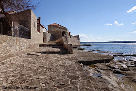The Adriatic Sea meets the old stone wall in Novigrad, Croatia
