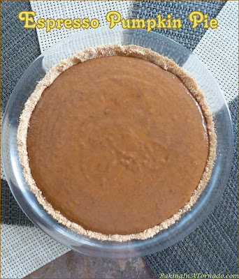 Espresso Pumpkin Pie, a classic holiday dessert gets an upgrade. Silky pumpkin pie is infused with a coffee flavored boost. | Recipe developed by www.BakingInATornado.com | #bake #pie