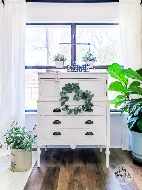 white cottage dresser and greenery