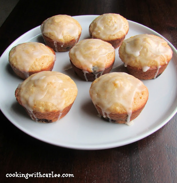 lemon, blueberry and summer squash muffins ready to eat plate of muffins with white glaze on top