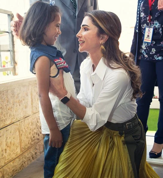 Queen Rania wore Sacai pleated midi skirt, Maison Makarem balloon shirt, Dior pumps and she carried Marni Trunk shoulder bag