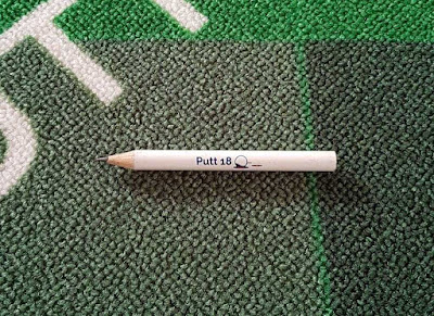 A Putt18 Golf Putting Mat Game pencil