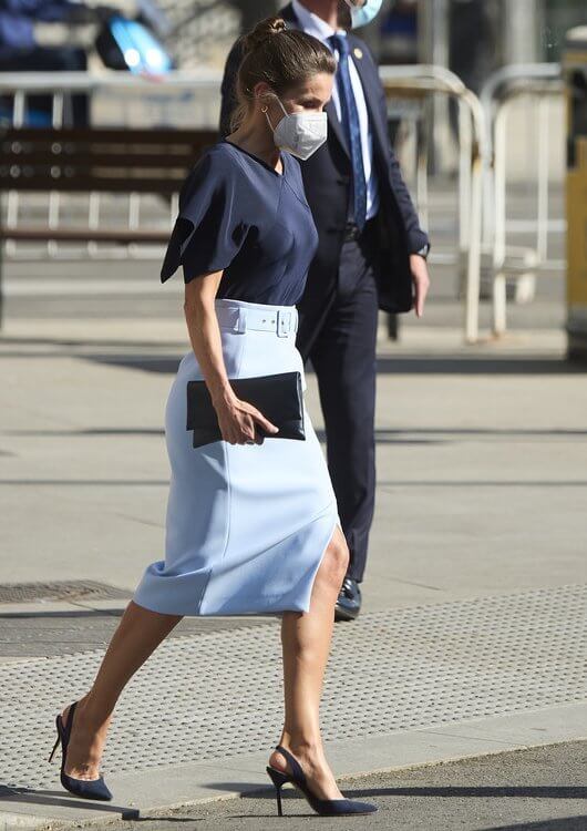Queen Letizia wore a v-neck pure silk flared sleeves navy blue top and a sky-blue high waisted pencil skirt from Hugo Boss
