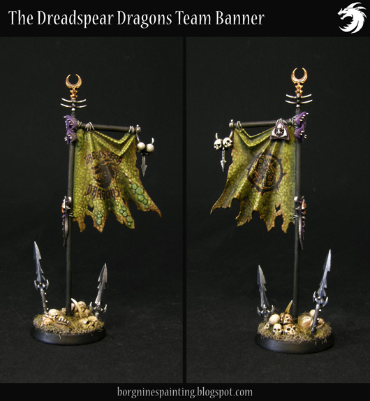 A compilation of two pictures showing both sides of a miniature banner - it is painted to look like a green dragon skin and has both the team's and Blood Bowl's logo freehanded on it. Skulls and spearheads are scattered around the base.