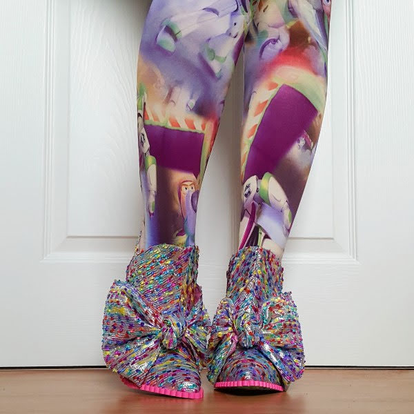 wearing buzz Lightyear tights with silver booties with large bows
