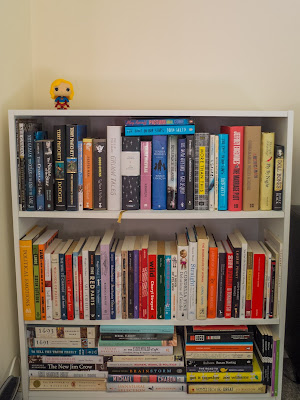White bookcase with Supergirl Pop figurine on top