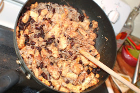 A big pan of black beans and rice with sauteed chicken
