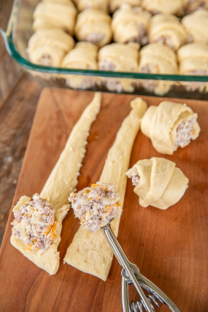 Ham & Cheese Crescent Breakfast Casserole - seriously the BEST!!! Crescent rolls, ham, cheese, brown sugar, Worcestershire sauce, cream cheese, dijon mustard, eggs, and milk. SO simple and SOOO delicious! Great for breakfast, brunch, lunch, dinner, and tailgating! Everyone LOVED this easy breakfast casserole. They cleaned their plates and asked for seconds. Success!!! #breakfast #casserole #ham #breakfastcasserole topping crescent rolls with chopped ham