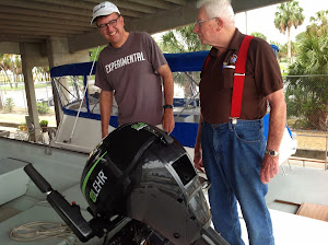 Hugh and Fred admire Chucky's  Propane motor. No more gasoline!