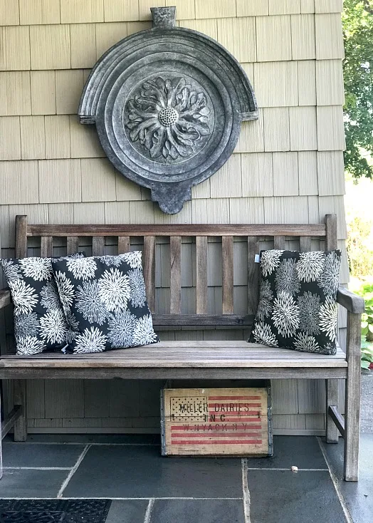 front stoop with teak bench and pillows