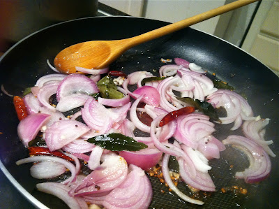 onions dried chillies mustard fenugreek curry leaves in pan