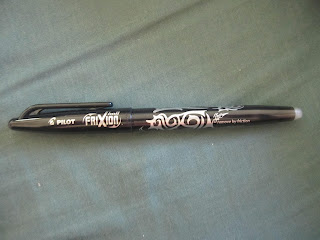 typical black ballpoint pen labelled 'frixion'