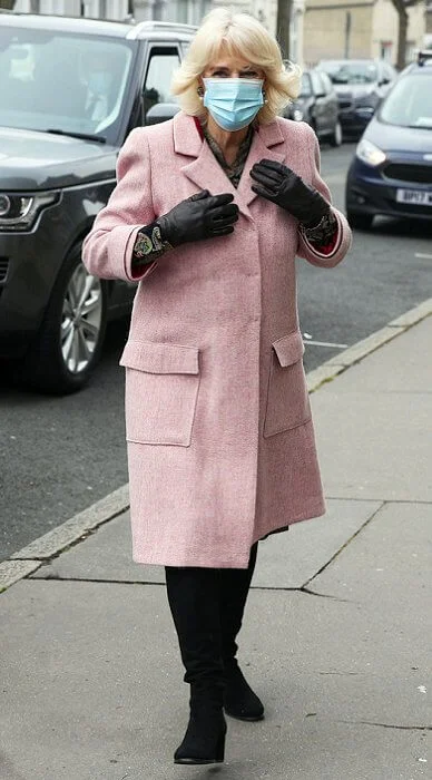 The Duchess met with those involved in the vaccination process, including NHS staff, volunteers and representatives. Pink wool coat and black boot