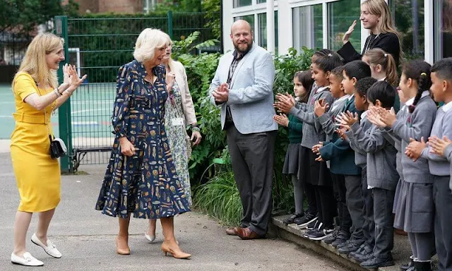 The Duchess of Cornwall wore a navy blue, feather-print dress from Fiona Clare