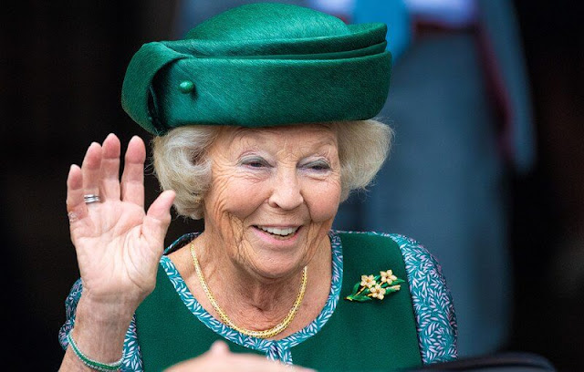 The Princess wore a green embroidered skirt suit, embroidered cape and green hat, gold brooch