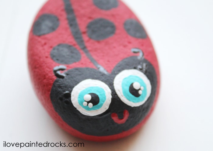 how to paint a ladybug rock. this is a super easy rock painting tutorial that is easy enough for kids