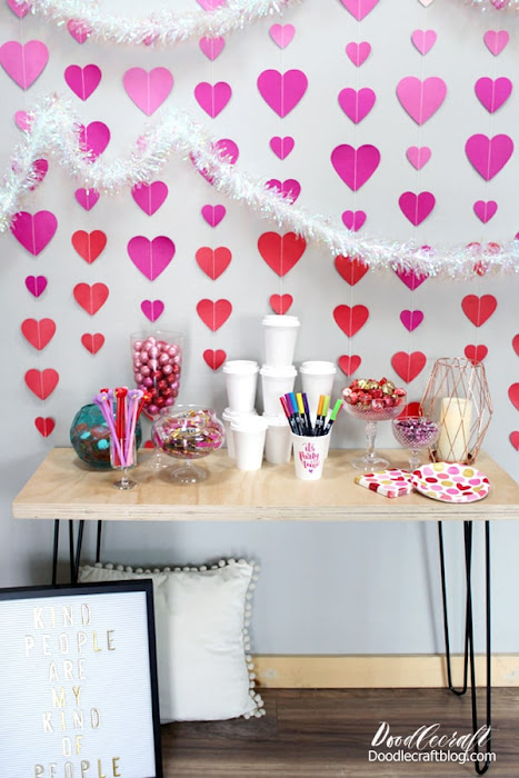 Use a hairpin leg table, a letterboard with a cute saying, some candy dishes, an ombre heart backdrop and some paper coffee cups to decorate for the perfect Galentine's day party.